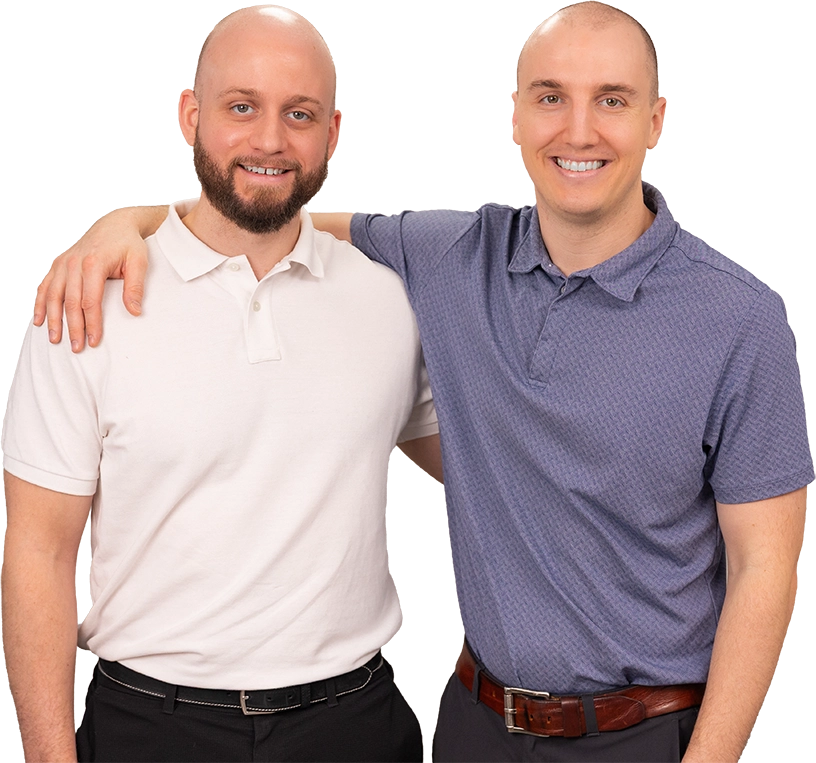 Two men with arms around each other, smiling at the camera, wearing polo shirts.